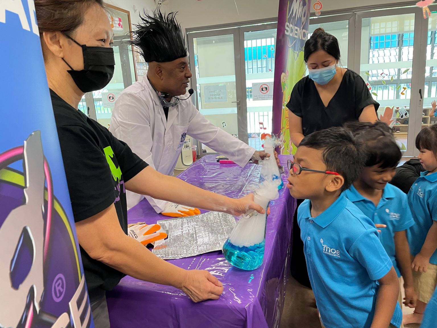 Children experiencing blowing carbon dioxide that was produced from dry ice in water.